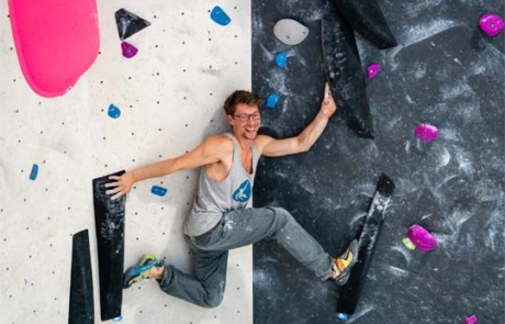 urban apes Hamburg Ost Mann lachend an der Boulderwand